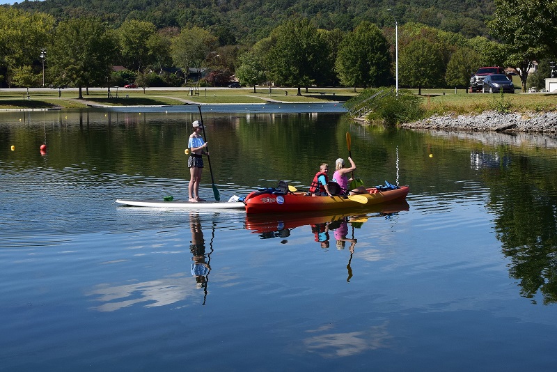 "An Inflatable Kayak Board and a Kayak Board in the lake